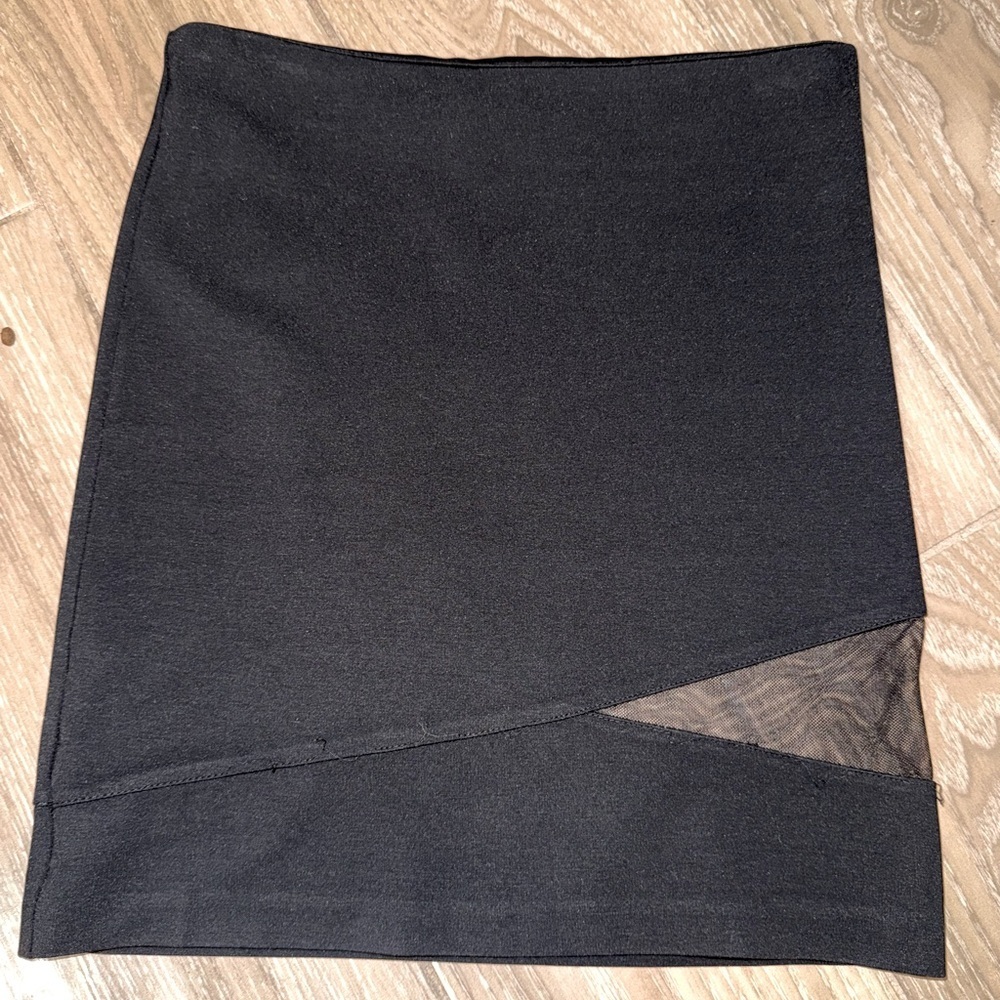 Black mini skirt BB Dakota featuring a unique diagonal sheer mesh panel detail.4
